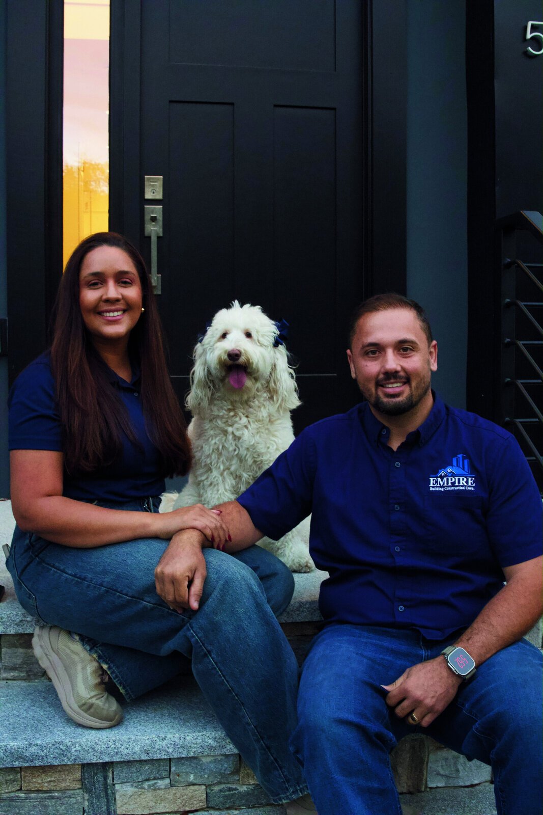 Jefferson and Lailla Escola with their dog in front of a finished home