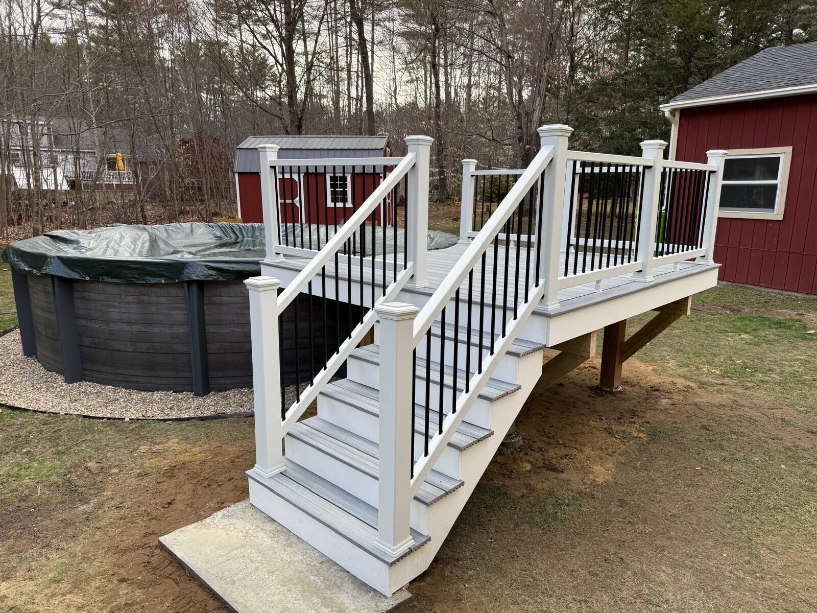New gray vinyl siding with white trim on a two-story home in Framingham, MA