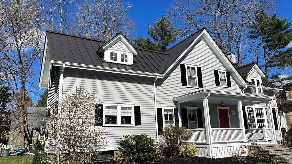 Standing seam metal roof on a farmhouse-style home in Massachusetts